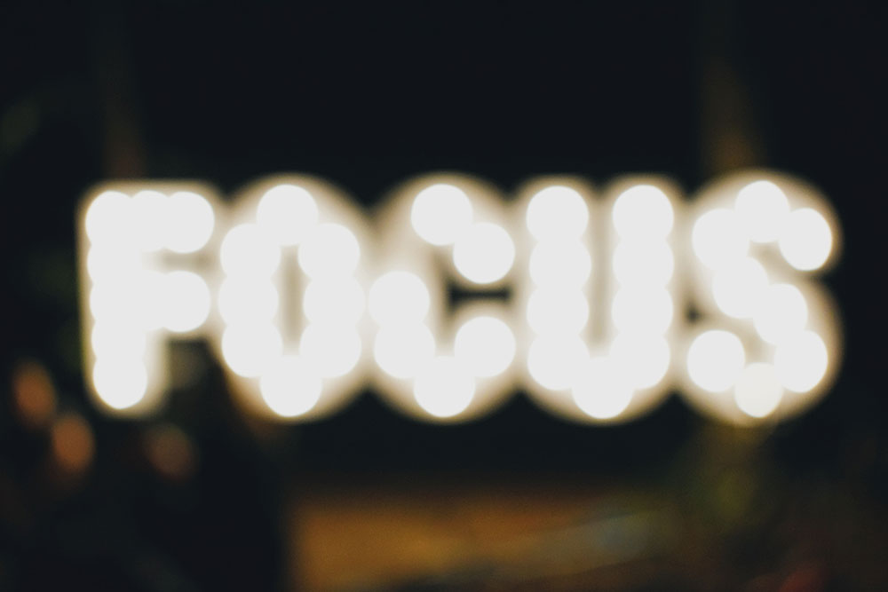 The word "focus" shown out of focus.